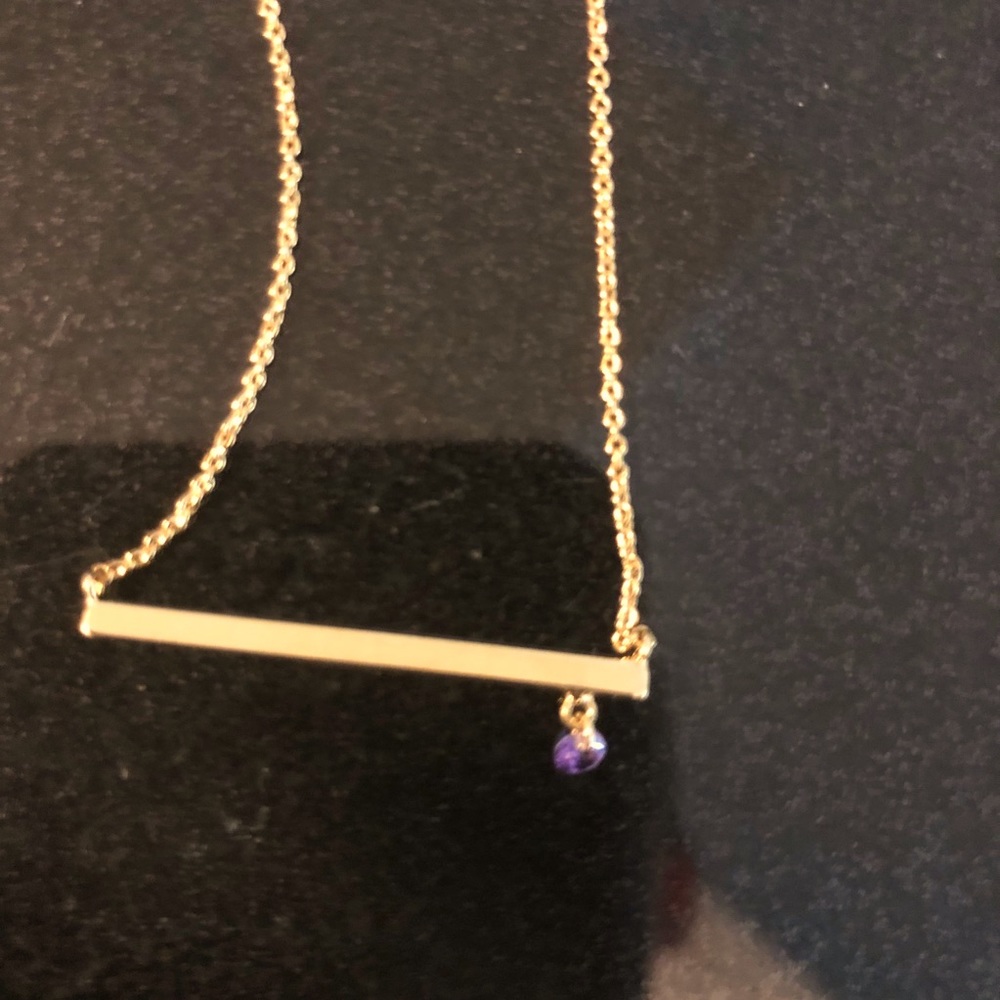 Delicate gold necklace with tiny purple charm